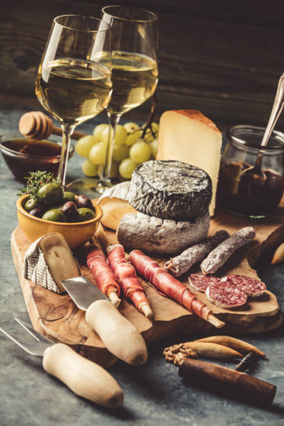 istock White wine with charcuterie assortment on the stone background 1145772277