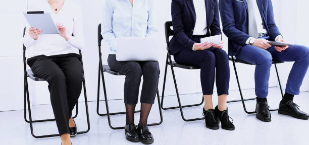 istock Group of business people sitting in office and waiting for job interview while using gadgets, close-up. Conference or training concepts 1145773701