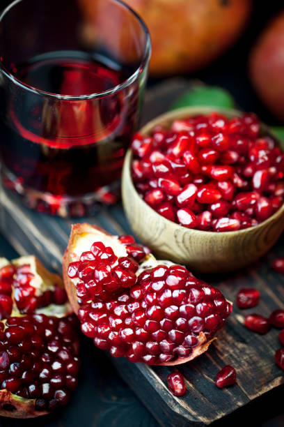 istock Ripe pomegranate fruit on a old black wooden vintage background. Selective focus. 1145773873