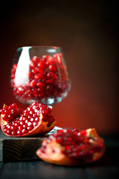 istock Ripe pomegranate fruit on a old black wooden vintage background. Selective focus. 1145774772