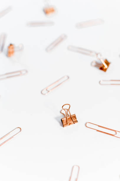 istock Paper clips copper color on white background. 1145775640