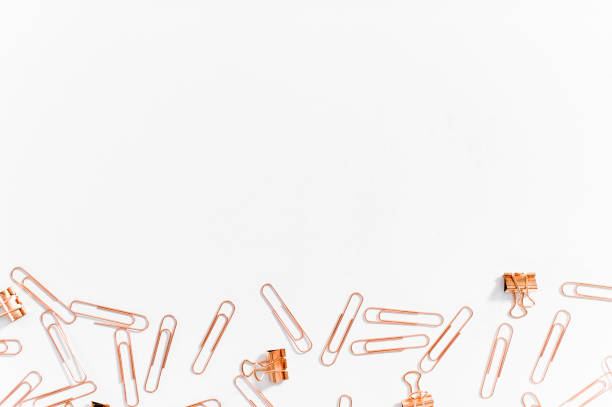istock Paper clips copper color on white background. 1145775671