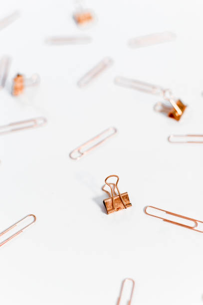 istock Paper clips copper color on white background. 1145775720