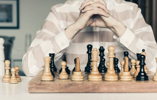 istock Wooden chess pieces on a chessboard, chess game woman player makes a move 1145776027