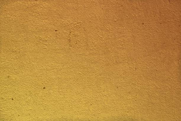 istock yellow solid shabby stucco on the wall texture - beautiful abstract photo background 1145776604