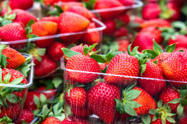 istock red strawberries pattern in market, fresh strawberries texture, fruit 1145779520