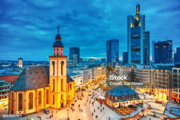 View To Skyline Of Illuminated Frankfurt Am Main During Twilight Sunset St Catherines Church And The Hauptwache Main Guard Building With Famous Frankfurt Skyscrapers Frankfurt Center In Germany Stock Photo - Download Image Now