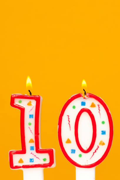 istock Colorful wax birthday candle  on orange background 1145782450