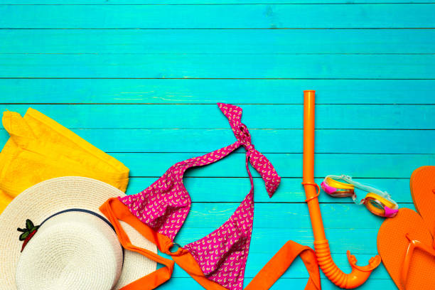 istock Composition with swimsuit on color wooden background 1145783163