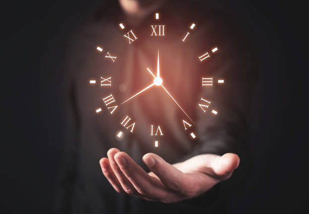 istock Man holding clock. Business time management 1145783300