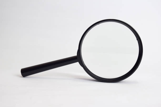 istock Close up Magnifying glass loupe isolated on white background 1145784261