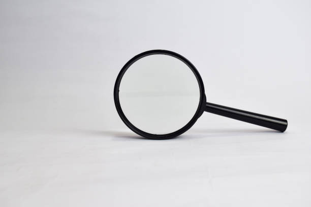 istock Close up Magnifying glass loupe isolated on white background 1145784262