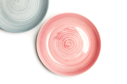 A pink plate and part of a light blue plate on an isolated view