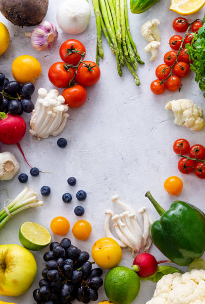 istock Top view flat lay with various vegetables on concrete background. Enoki mushrooms, asparagus, cherry tomatoes and berries. Summer food ingredients concept 1145796003