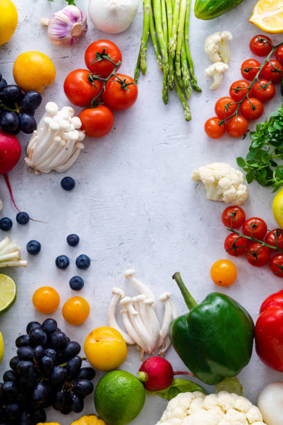 istock Top view flat lay with various vegetables on concrete background. Enoki mushrooms, asparagus, cherry tomatoes and berries. Summer food ingredients concept 1145796004