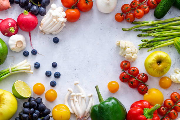 istock Top view flat lay with various vegetables on concrete background. Enoki mushrooms, asparagus, cherry tomatoes and berries. Summer food ingredients concept 1145796015