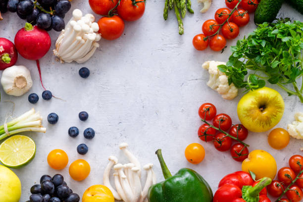 istock Top view flat lay with various vegetables on concrete background. Enoki mushrooms, asparagus, cherry tomatoes and berries. Summer food ingredients concept 1145796041