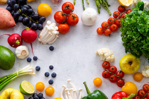 istock Top view flat lay with various vegetables on concrete background. Enoki mushrooms, asparagus, cherry tomatoes and berries. Summer food ingredients concept 1145796045