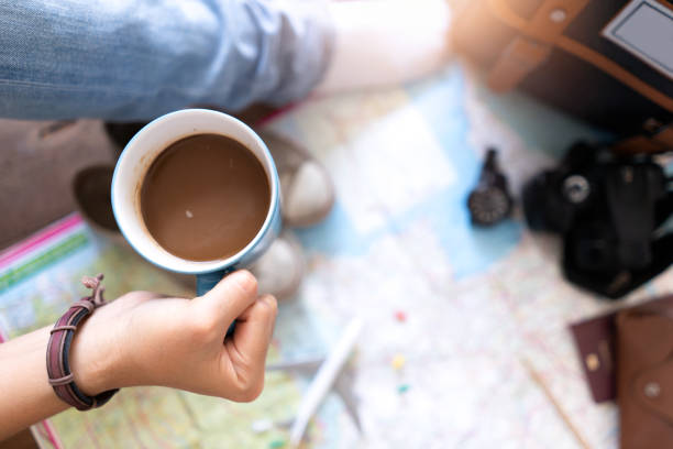 istock Hand hold coffee and planning for travel 1145797303