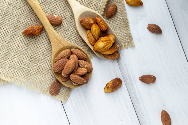 istock Almonds in a black bowl against dark rustic wooden background 1145797414