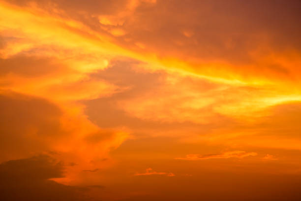 istock Cloudy sky and orange light of the sun through the clouds with copy space 1145797807