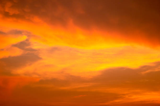 istock Cloudy sky and orange light of the sun through the clouds with copy space 1145797809