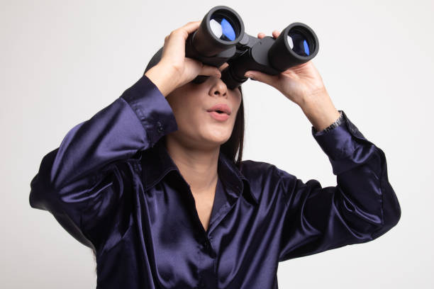 istock Young Asian woman with binoculars. 1145799183