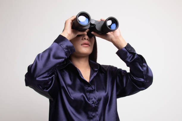 istock Young Asian woman with binoculars. 1145799530