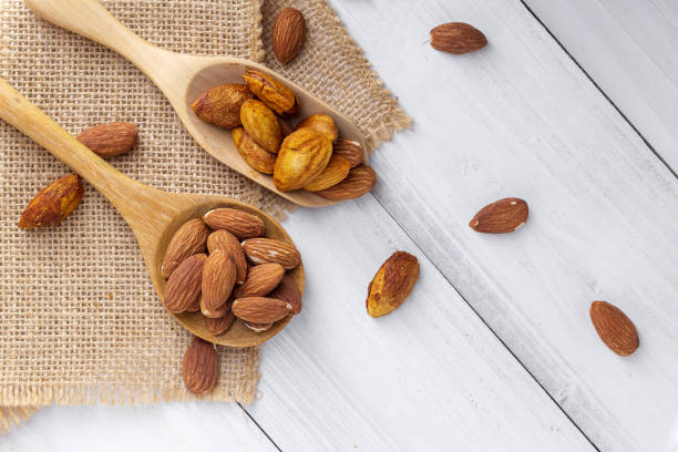 istock Almonds in a black bowl against dark rustic wooden background 1145799654