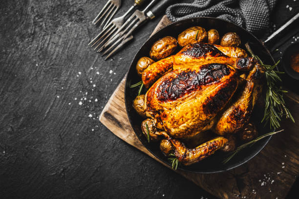 istock Baked whole chicken with spices on pan 1145802616