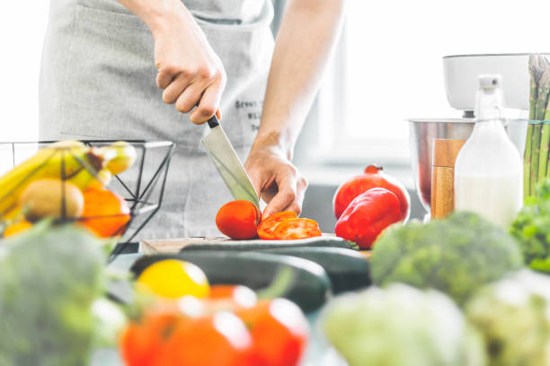 istock Young man chef cooking healthy salad 1145802765