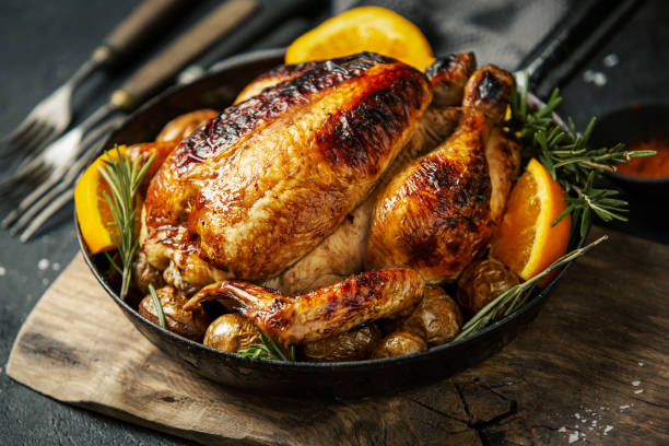 istock Baked whole chicken with spices on pan 1145805711