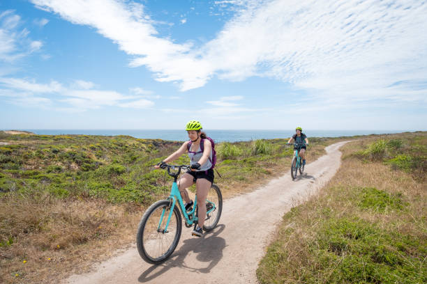 istock Multi-Ethnic, Millennial Sisters Bicycling on Single Track Path, California Coastline 1145806307