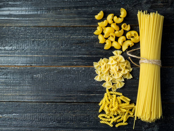 istock Raw pasta on a wooden table 1145812244
