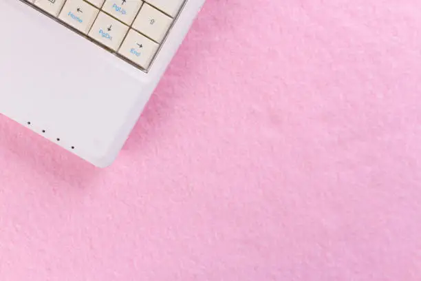 Photo of computer on pink background