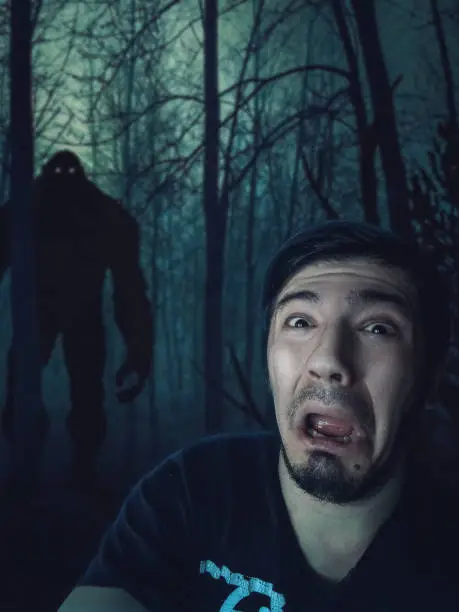 Man scared by King-Kong in dark forest at the night