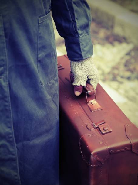 istock man with old leather suitcase and gloves 1145814119