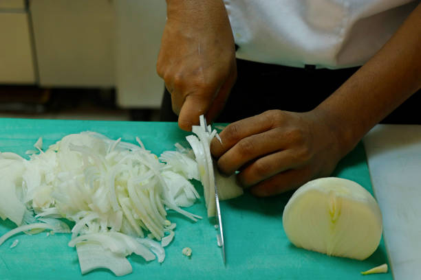 istock a chef slicing white onion on a green cutting board 1145814261