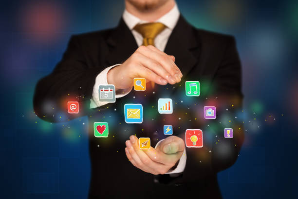 istock Businessman holding application icons 1145814290