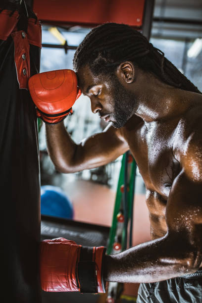 istock Exhausted sweaty boxer taking a break from sports training. 1145814456