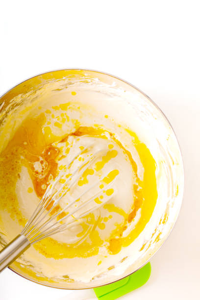 istock Baking bakery concept whipped eggs mix with ingredients for homemade sponge cake on white background 1145815949