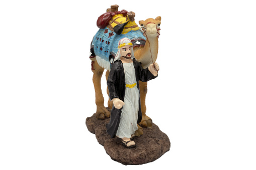 Arabian man walk with his camel doll from resin for show and souvenir