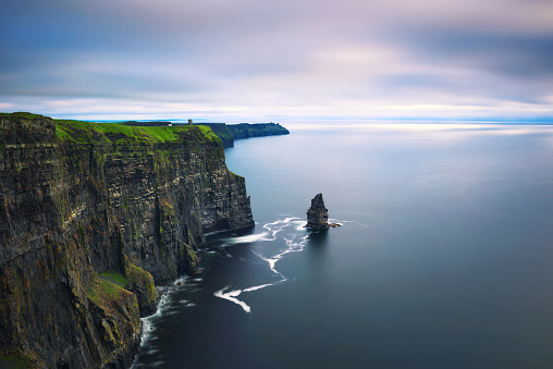 Panoramic view of the scenic Cliffs of Moher in Ireland. This popular tourist attraction is situated in County Clare along the Wild Atlantic Way. Long exposure.