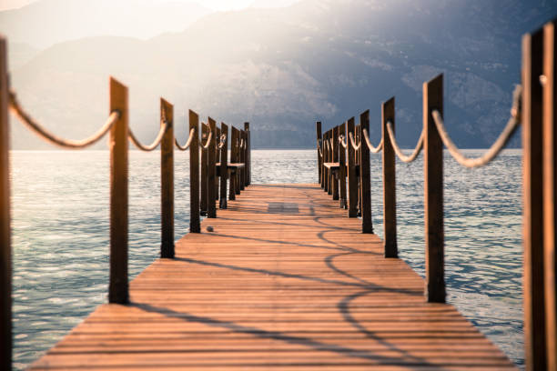 mother and son on wooden pier at Lake Garda in  Italy