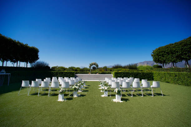 Sunny Outdoor Wedding Ceremony Area with arch of flowers Sunny Outdoor Wedding Ceremony Area with an arch of flowers Stellenbosch South Africa country wedding arches stock pictures, royalty-free photos & images