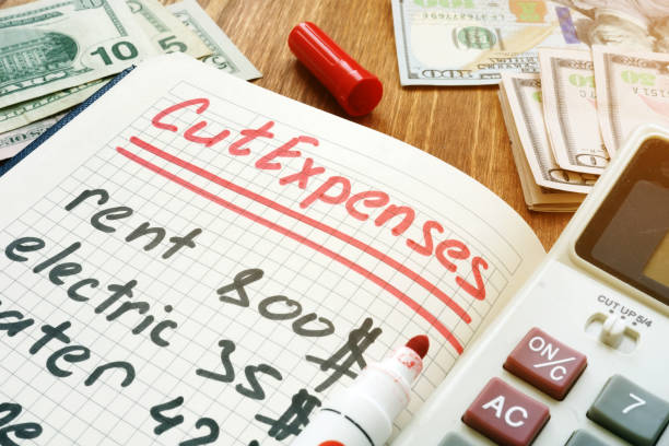 istock Cut Expenses for monthly home budget. Note pad and calculator. 1145828368