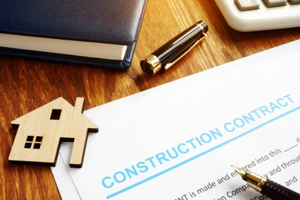 istock Construction contract, model of house and calculator. 1145829421