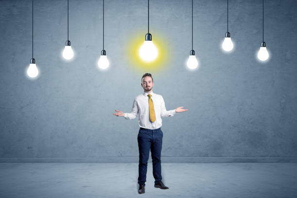 istock Businessman standing uninspired with bulbs above 1145832612