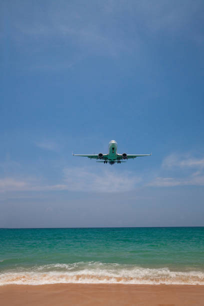 istock airplane landing close to the beach 1145832681