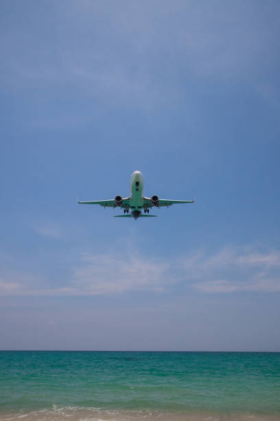 istock airplane landing close to the beach 1145832783